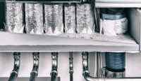 Rohrdurchführungen durch die Kellerdecke in den Geberit Quattro Installationsschacht mit Geberit Deckenverschluss-System FSH 90 und Medienleitungen mit Nullabständen. 