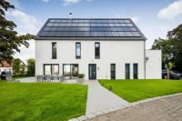 Bei Sonnenhäusern erzeugen große Solarthermie- und Photovoltaikanlagen Energie für Wärme, Strom und Mobilität. Mit der stark verbesserten Förderung der KfW und des BAFA wird die Bauweise, die CO2 und Energiekosten einspart, unterstützt. <br />Bild: Sonnenhaus-Institut