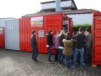Herr Meisl (Leiter Personal und Innenorganisation) zeigt den Auszubildenden bei der Führung durchs Firmengelände eine 2-MW-Heizzentrale, die ganze Wohnviertel übergangsbeheizen kann. 