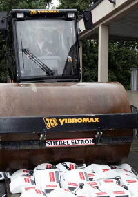 Der Vorsitzende der Geschäftsführung bei STIEBEL ELTRON Rolf Sonnemann unterstützt den Fahrer der Walze.